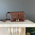 Chylak glossy brown crocodile leather belt bag at Palace of Nowhere