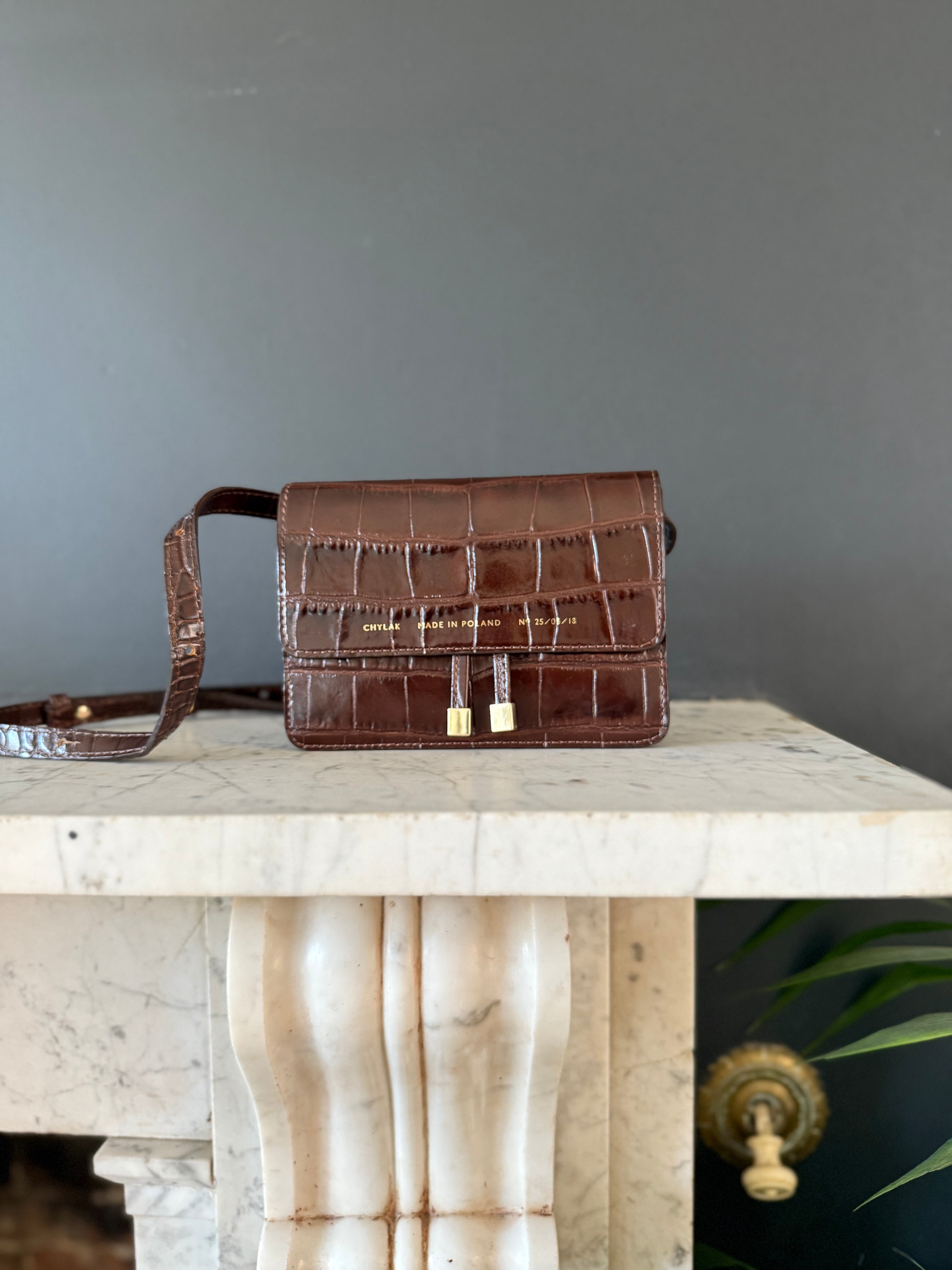 Chylak glossy brown crocodile leather belt bag at Palace of Nowhere