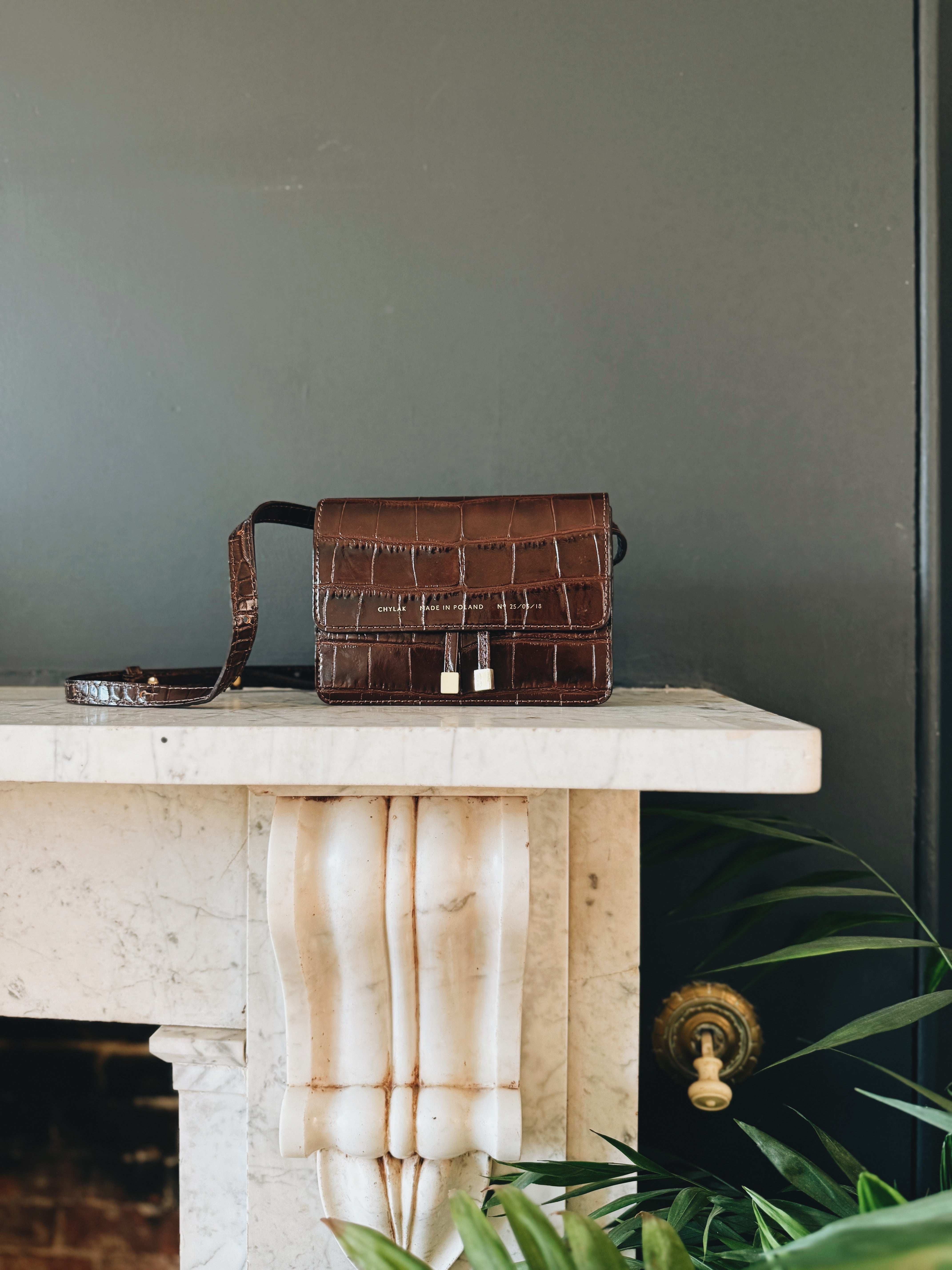 Chylak glossy brown crocodile leather belt bag at Palace of Nowhere