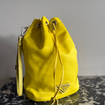 Prada neon yellow drawstring nylon bucket bag at Palace of Nowhere