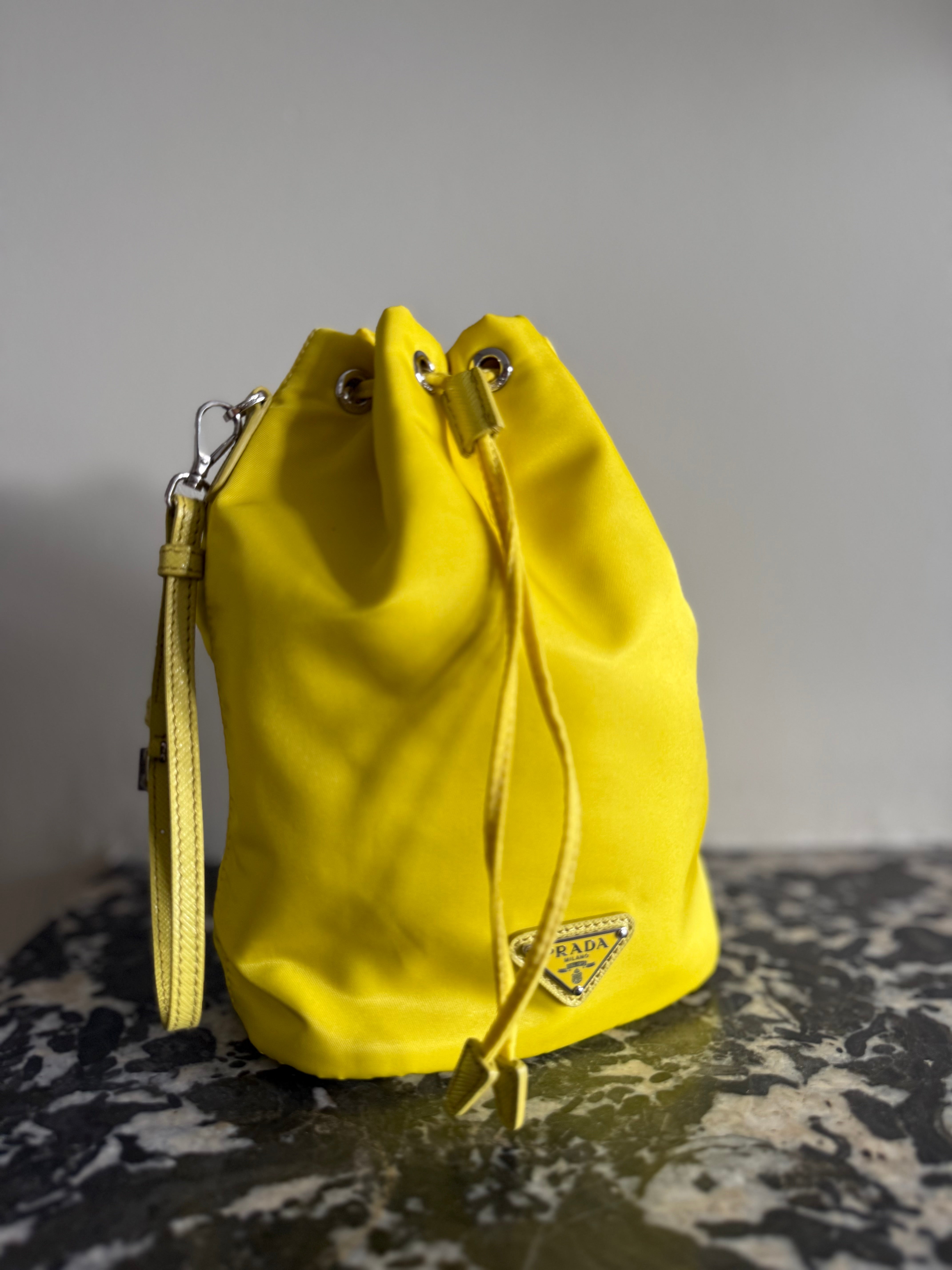 Prada neon yellow drawstring nylon bucket bag at Palace of Nowhere