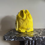 Prada neon yellow drawstring nylon bucket bag at Palace of Nowhere