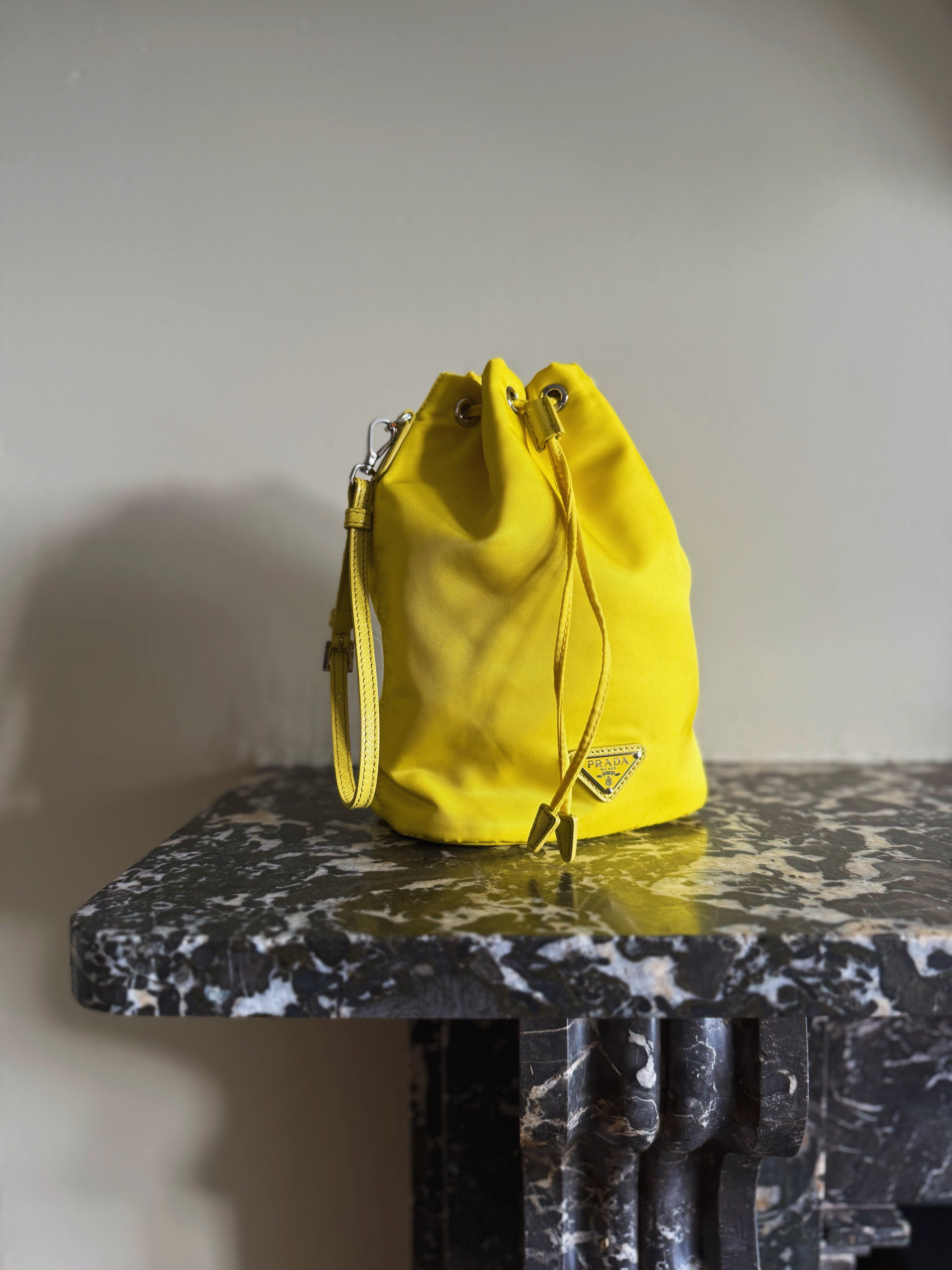 Prada neon yellow drawstring nylon bucket bag at Palace of Nowhere
