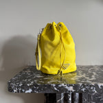 Prada neon yellow drawstring nylon bucket bag at Palace of Nowhere