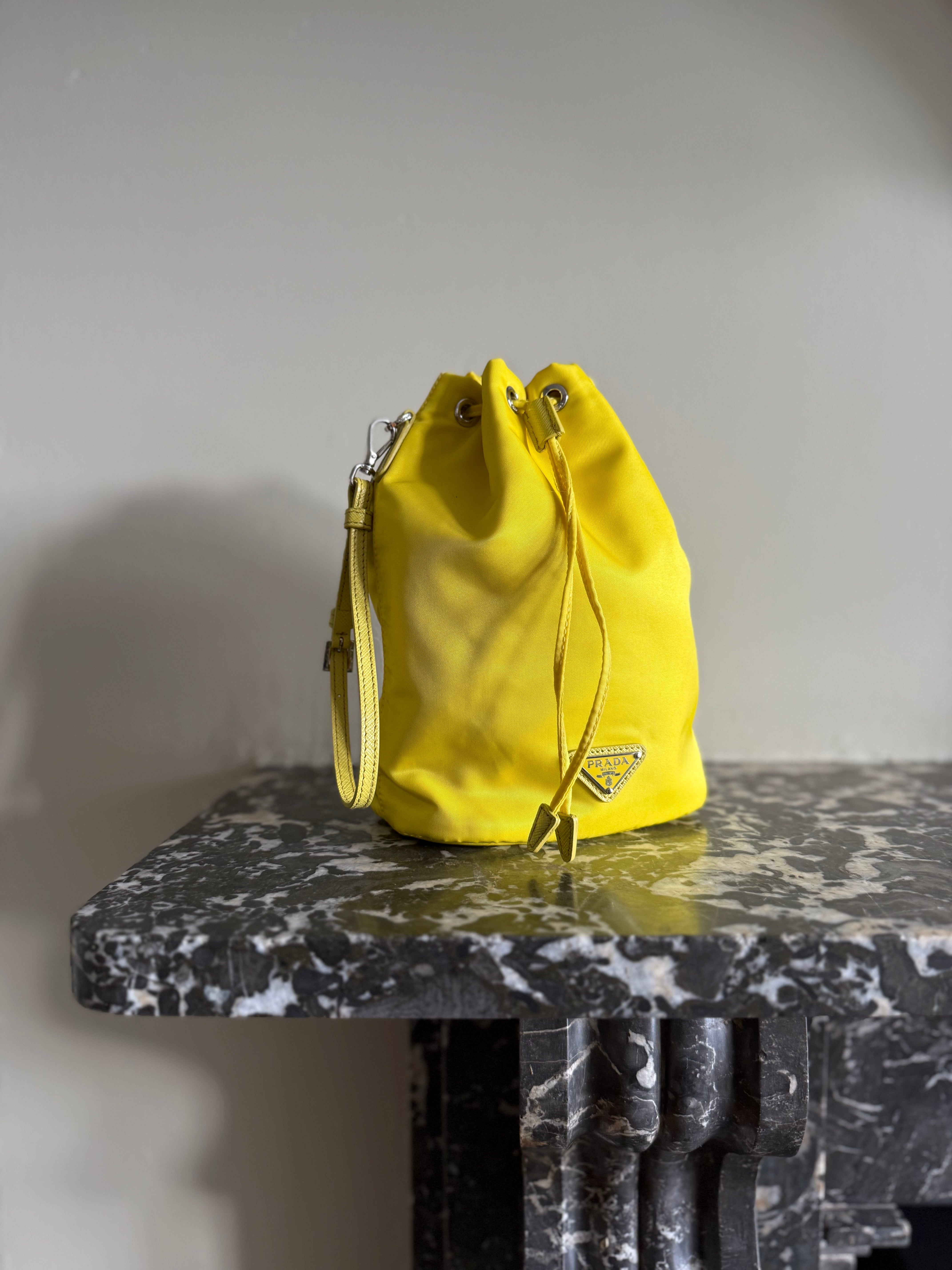 Prada neon yellow drawstring nylon bucket bag at Palace of Nowhere